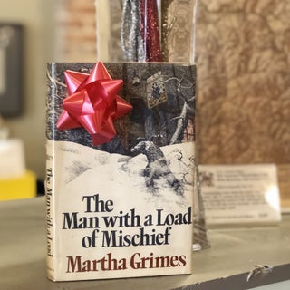 Item #12356 The Man with a Load of Mischief. Martha Grimes